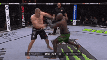 two men are fighting in a boxing ring and the ufc fight pass is displayed