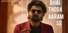 a man with a beard wearing sunglasses and a red jacket
