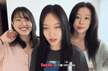three girls are standing next to each other with one wearing a saera shirt