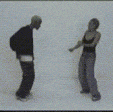 a man and a woman are dancing in front of a white wall