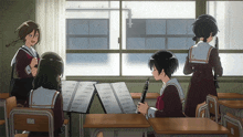 a girl playing a clarinet in a classroom with x on her uniform