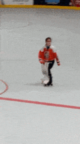 a blurry picture of a person playing a game of ice hockey on a rink .
