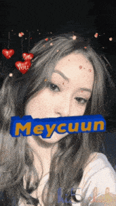 a girl with hearts on her head and the name meycuun