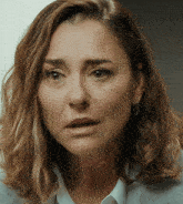 a close up of a woman 's face with a sad look on her face