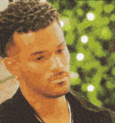 a close up of a man 's face with a christmas tree in the background