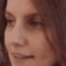 a close up of a woman 's face with long hair .