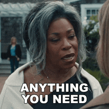 a woman says " anything you need " in front of another woman