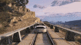 a video game scene with a car on the tracks and the words " seming gi sogni " on the bottom