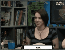 a woman named ava is sitting in front of a shelf of books