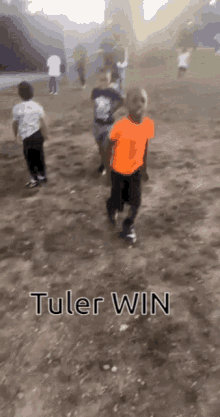 a group of children are running in a dirt field with the words tuler win written on the bottom