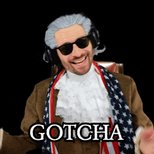 a man with a scarf around his neck is wearing gotcha