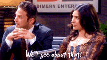 a man and woman are sitting in front of a sign that says dimera enterpr