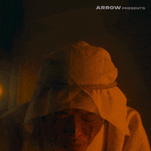a man with arabic writing on his face and the words arrow presents
