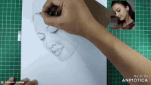a person is drawing a woman 's face on a piece of paper made in animatica