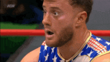 a man in a wrestling ring is wearing an american flag outfit