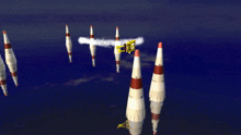 a bunch of rockets are flying in the sky and one of them says ' a ' on it