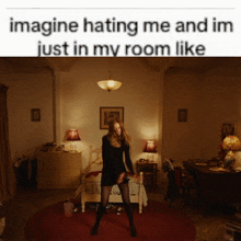 a woman in a black dress is dancing in a dark room with the words imagine hating me and im just in my room like