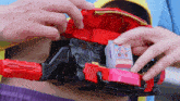 a person is playing with a toy car that has a sticker that says ' a ' on it