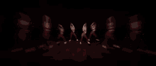 a group of women are dancing in a dark room