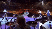 a group of people playing instruments on a stage in front of a crowd