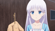 a girl with white hair and blue eyes holds a key in her hand