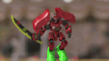 a toy robot with a sword and green legs