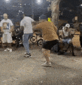 a group of men are dancing on a sidewalk in front of a restaurant .