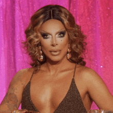 a drag queen is making a funny face with her mouth open