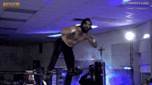 a man in a wrestling ring with the words pathwrestling on the ceiling