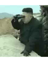a man in a black jacket is drinking from a glass
