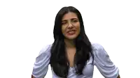 a woman in a white top is holding her hair and smiling