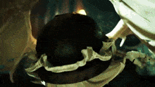a close up of a person holding a ball with a candle in it .