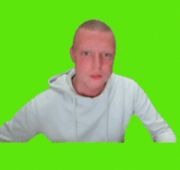 a man in a white sweatshirt is giving a thumbs up on a green screen