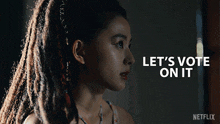 a woman with dreadlocks and the words let 's vote on it on the bottom