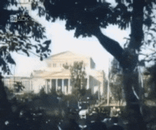 a blurry picture of a building with the letters ack visible