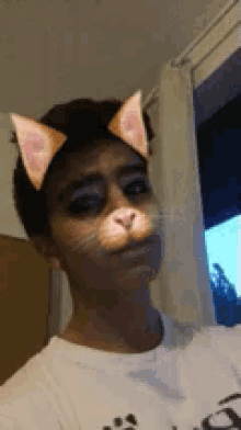 a young man wearing cat ears and a white shirt