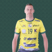 a man wearing a yellow shirt with the number 19 on the front