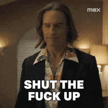 a man in a suit says shut the fuck up in front of a max logo