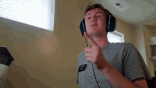 a man wearing headphones has a name tag on his shirt that says ' abercrombie & fitch '