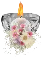 a candle in a glass surrounded by flowers and glitter