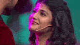 a close up of a woman with a microphone on her head .