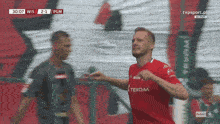 a soccer player in a red shirt with the word texo on it