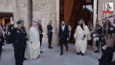 a group of men in military uniforms are standing in front of a sign that says arabian gulf