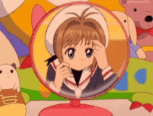 a girl is looking at herself in a round mirror