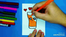 a person is drawing a glass of orange juice