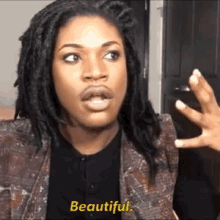 a woman with dreadlocks is talking to someone and they say beautiful