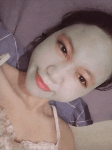 a woman with a green face mask on her face