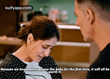 a woman is crying while talking to a man .