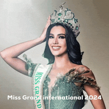 a miss grand international 2024 poster with a woman wearing a crown and sash
