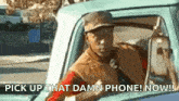a man is driving a truck and says pick up that damn phone now